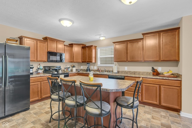 10731 Jimmy Lake Dr, Indianapolis, IN 46239 - kitchen featuring stainless steel fridge, black microwave, a kitchen bar, and stone finish floors