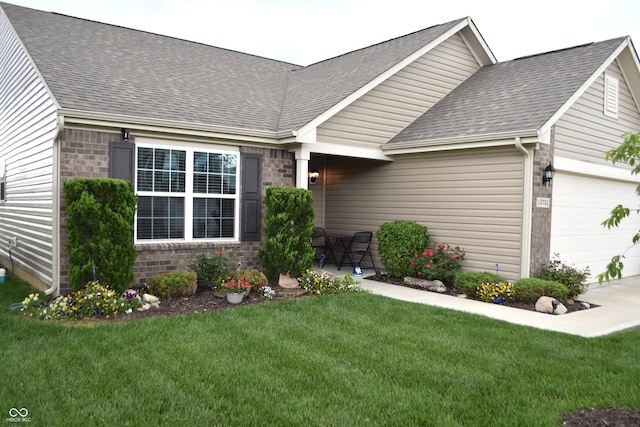 10731 Jimmy Lake Dr, Indianapolis, IN 46239 - view of front of home featuring an attached garage, a shingled roof, a front yard, and brick siding