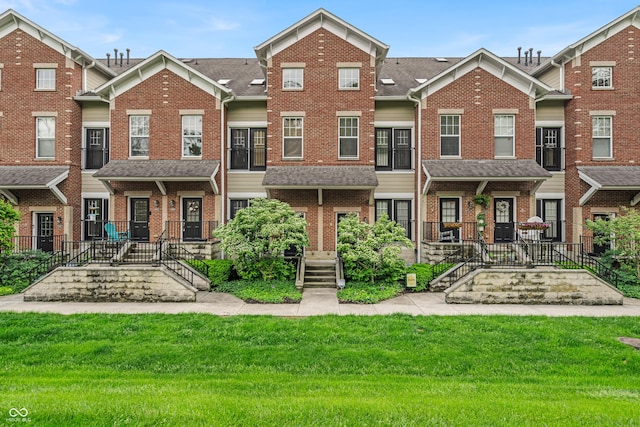 1064 Reserve Way, Indianapolis, IN 46220 - view of property with brick siding, a front yard, and roof with shingles