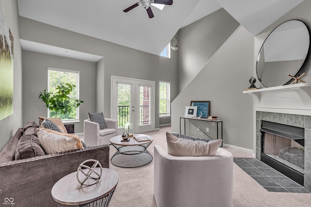 1064 Reserve Way, Indianapolis, IN 46220 - living room with carpet flooring, a tile fireplace, a ceiling fan, a high ceiling, and baseboards