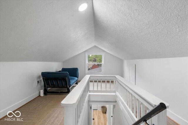 450 Historic Pleasant St, Noblesville, IN 46060 - staircase with a textured ceiling, baseboards, and lofted ceiling