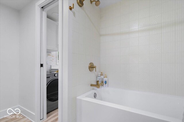 450 Historic Pleasant St, Noblesville, IN 46060 - bathroom featuring washer / clothes dryer, bathtub / shower combination, and wood finished floors