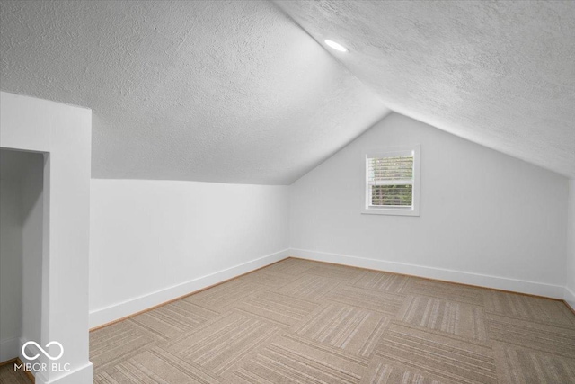 450 Historic Pleasant St, Noblesville, IN 46060 - bonus room with a textured ceiling, vaulted ceiling, baseboards, and carpet