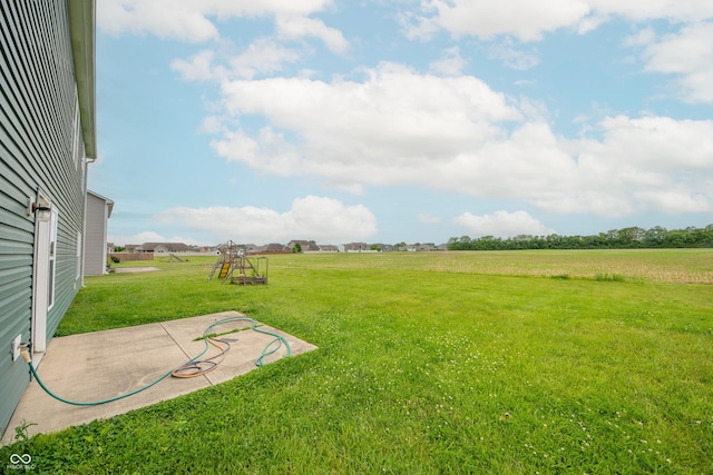 4712 Clairmont Dr, Columbus, IN 47203 - view of grassy yard with a patio area