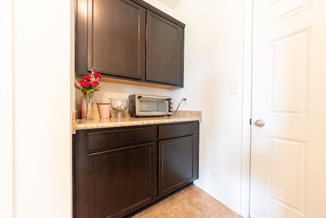4712 Clairmont Dr, Columbus, IN 47203 - bar area with baseboards and light tile patterned floors