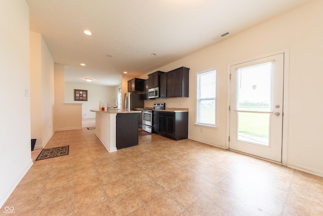 4712 Clairmont Dr, Columbus, IN 47203 - kitchen featuring stainless steel appliances, a center island with sink, recessed lighting, baseboards, and dark brown cabinets