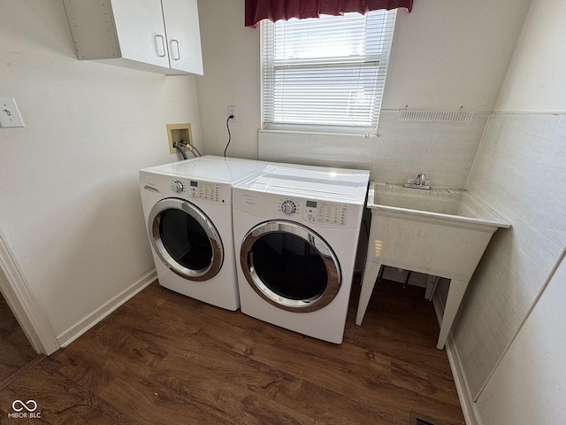 7970 Cobblesprings Dr, Avon, IN 46123 - clothes washing area with dark wood-type flooring, washing machine and clothes dryer, cabinet space, and tile walls