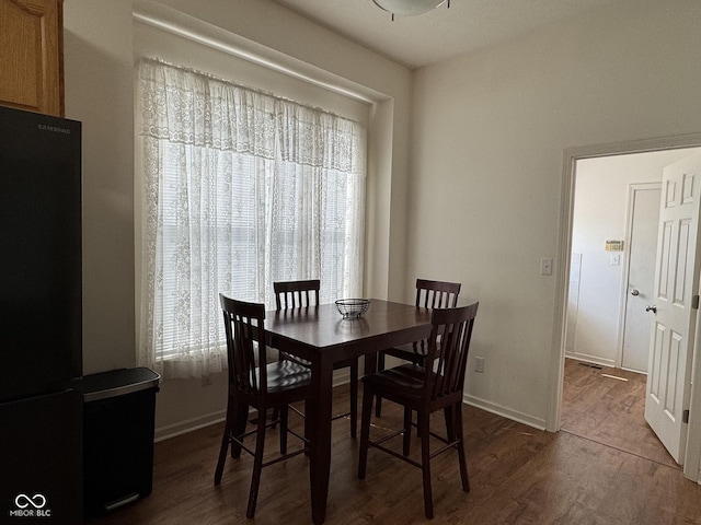 7970 Cobblesprings Dr, Avon, IN 46123 - dining space with dark wood-style floors and baseboards