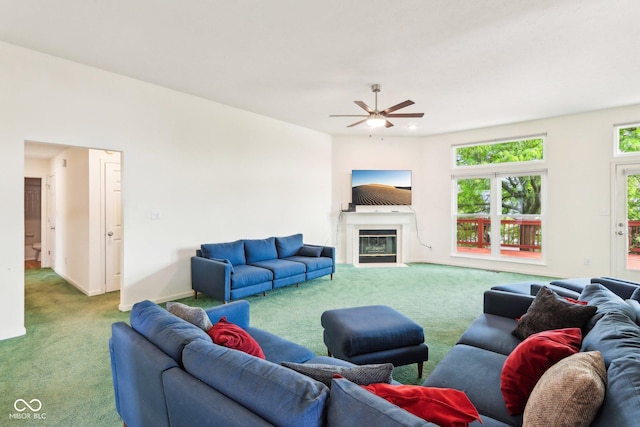 7970 Cobblesprings Dr, Avon, IN 46123 - living room featuring carpet flooring, a glass covered fireplace, a ceiling fan, and baseboards