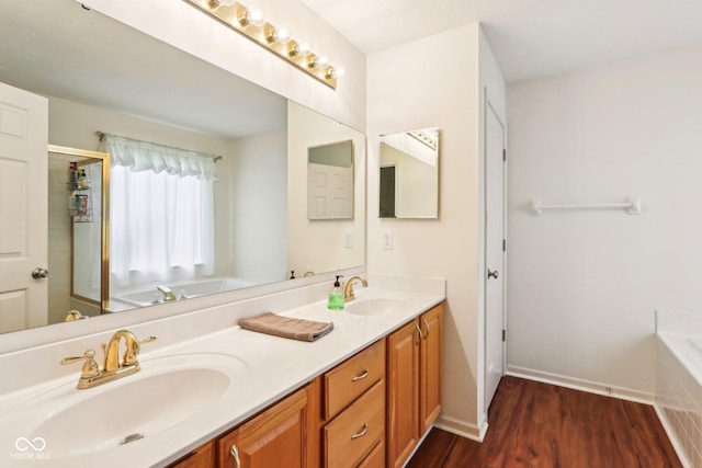 7970 Cobblesprings Dr, Avon, IN 46123 - bathroom with double vanity, a garden tub, wood finished floors, and an enclosed shower