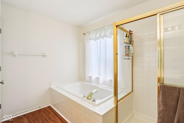 7970 Cobblesprings Dr, Avon, IN 46123 - bathroom featuring a stall shower, a garden tub, wood finished floors, and baseboards