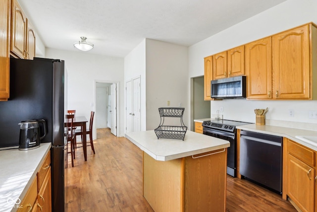 7970 Cobblesprings Dr, Avon, IN 46123 - kitchen with appliances with stainless steel finishes, wood finished floors, a center island, and light countertops