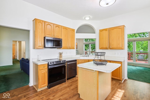 7970 Cobblesprings Dr, Avon, IN 46123 - kitchen with electric stove, dishwashing machine, light countertops, light wood-style floors, and a center island