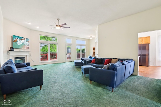 7970 Cobblesprings Dr, Avon, IN 46123 - living room featuring carpet flooring, ceiling fan, and a glass covered fireplace
