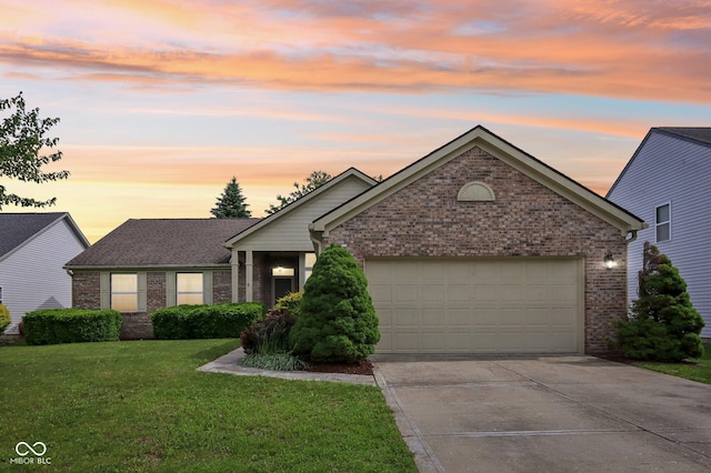 7970 Cobblesprings Dr, Avon, IN 46123 - view of front facade featuring brick siding, driveway, a garage, and a yard