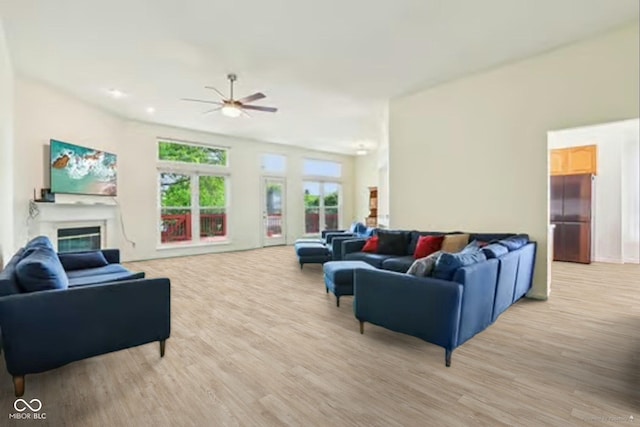 7970 Cobblesprings Dr, Avon, IN 46123 - living room featuring a ceiling fan, light wood-type flooring, and a glass covered fireplace