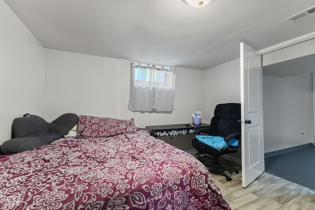 bedroom with wood finished floors and baseboards