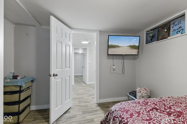 bedroom with wood finished floors and baseboards