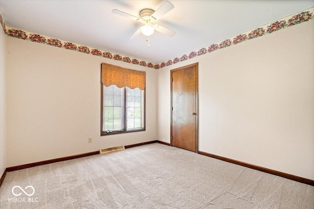 659 Carson Ct, Carmel, IN 46033 - spare room featuring light colored carpet, baseboards, and a ceiling fan
