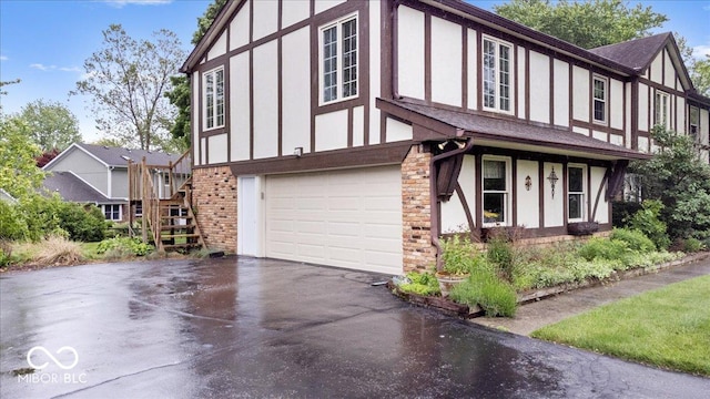 659 Carson Ct, Carmel, IN 46033 - view of front of house featuring driveway, an attached garage, brick siding, stairs, and roof with shingles