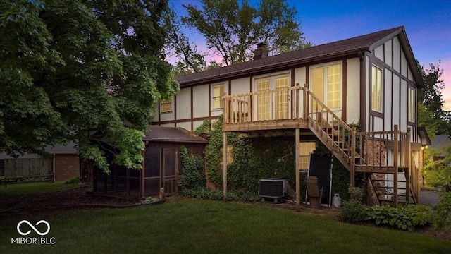 659 Carson Ct, Carmel, IN 46033 - rear view of property featuring stairs, a sunroom, a lawn, a chimney, and central AC unit