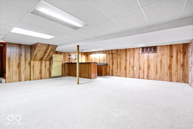 659 Carson Ct, Carmel, IN 46033 - finished below grade area featuring a paneled ceiling, wood walls, carpet, freestanding refrigerator, and a dry bar