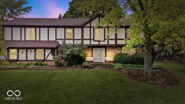 659 Carson Ct, Carmel, IN 46033 - english style home featuring a front yard, stucco siding, brick siding, and a chimney