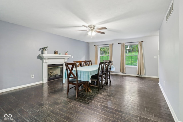 6804 Erika Ln, Nashville, IN 47448 - dining room with ceiling fan, a glass covered fireplace, wood finished floors, and baseboards