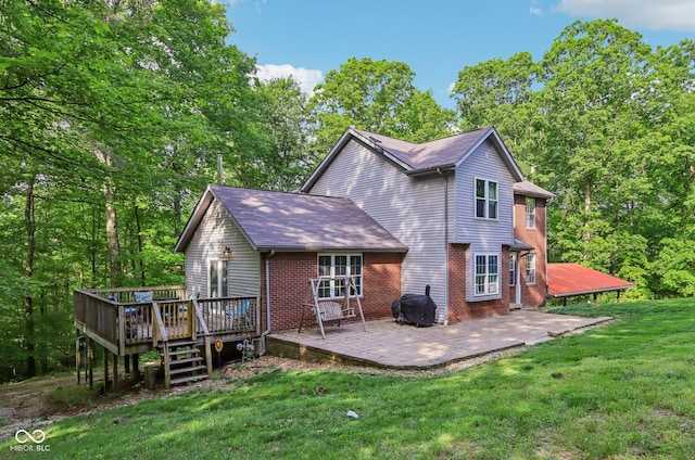 6804 Erika Ln, Nashville, IN 47448 - back of property featuring a lawn, a deck, a patio, and brick siding