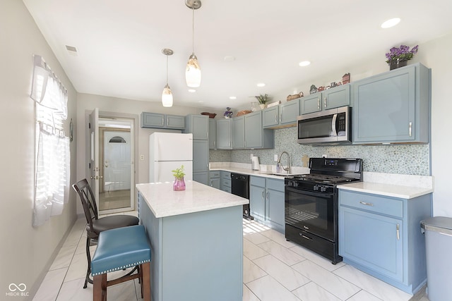 4967 Diana Dr, Indianapolis, IN 46203 - kitchen featuring black appliances, a sink, a kitchen bar, light countertops, and a kitchen island