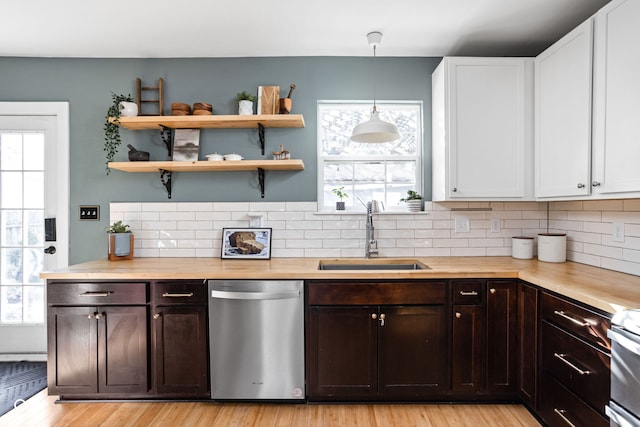 609 E 39th St, Indianapolis, IN 46205 - kitchen with stainless steel dishwasher, decorative backsplash, white cabinetry, and light wood-style flooring