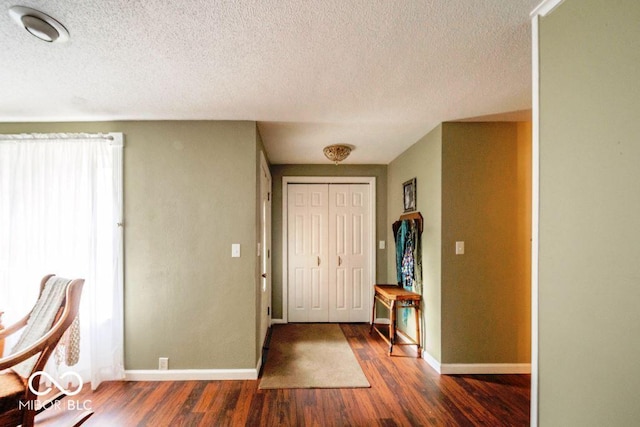 17310 N Willman Rd, Eaton, IN 47338 - foyer entrance with a textured ceiling, dark wood-style floors, and baseboards