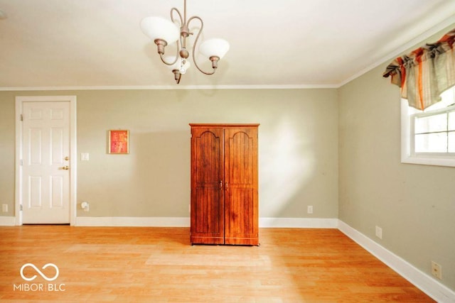 17310 N Willman Rd, Eaton, IN 47338 - unfurnished room with crown molding, light wood-type flooring, a chandelier, and baseboards