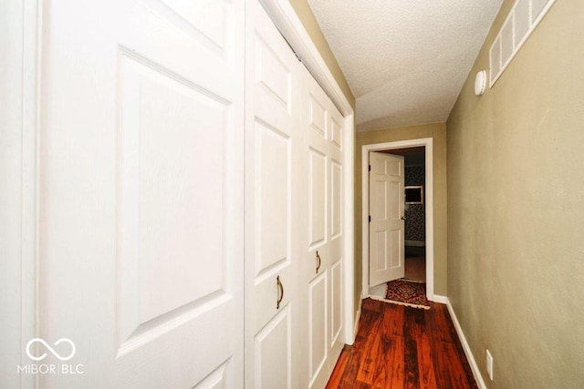 17310 N Willman Rd, Eaton, IN 47338 - hallway featuring dark wood-style floors, a textured ceiling, and baseboards