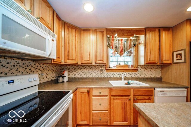 17310 N Willman Rd, Eaton, IN 47338 - kitchen with white appliances, a sink, tasteful backsplash, and brown cabinetry