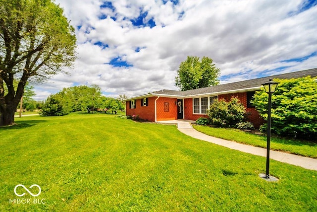 17310 N Willman Rd, Eaton, IN 47338 - ranch-style home featuring brick siding and a front yard