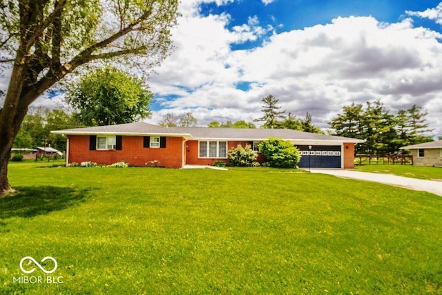 17310 N Willman Rd, Eaton, IN 47338 - ranch-style home featuring concrete driveway, an attached garage, brick siding, and a front yard