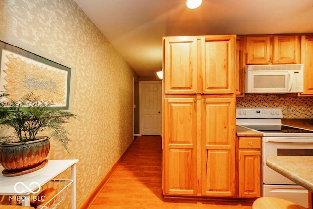 17310 N Willman Rd, Eaton, IN 47338 - kitchen featuring white appliances, wallpapered walls, light wood-type flooring, and brown cabinets
