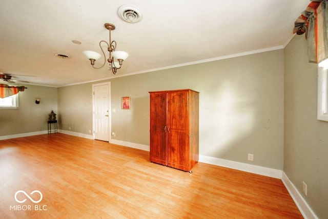 17310 N Willman Rd, Eaton, IN 47338 - unfurnished room featuring crown molding, light wood-style floors, a chandelier, baseboards, and ceiling fan