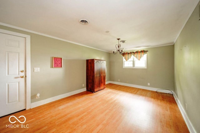 17310 N Willman Rd, Eaton, IN 47338 - empty room featuring light wood-style floors, a chandelier, crown molding, and baseboards