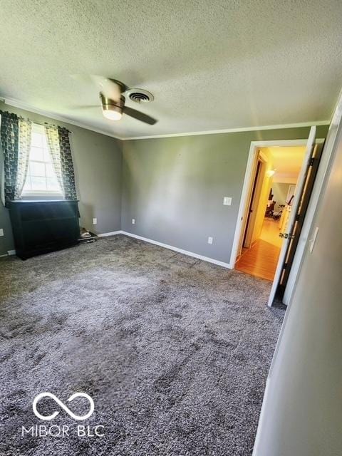 17310 N Willman Rd, Eaton, IN 47338 - unfurnished room with a textured ceiling, carpet floors, ceiling fan, baseboards, and ornamental molding