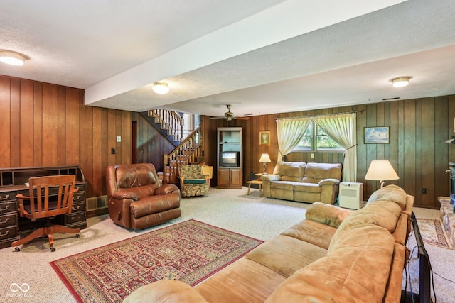 9240 E Woodview Dr, Bloomington, IN 47401 - carpeted living area featuring wooden walls, stairway, an office area, and a textured ceiling