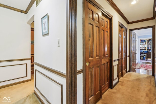9240 E Woodview Dr, Bloomington, IN 47401 - hallway featuring crown molding, light carpet, and a wainscoted wall