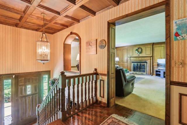 9240 E Woodview Dr, Bloomington, IN 47401 - corridor featuring an upstairs landing, wallpapered walls, arched walkways, coffered ceiling, and a wooden ceiling with exposed beams