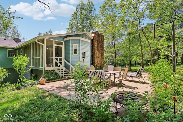 9240 E Woodview Dr, Bloomington, IN 47401 - rear view of property featuring a patio, a sunroom, and a chimney