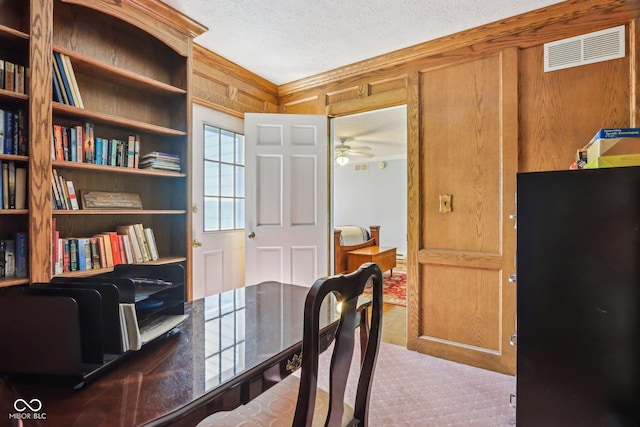 9240 E Woodview Dr, Bloomington, IN 47401 - office featuring a textured ceiling, a ceiling fan, wood walls, and wood finished floors