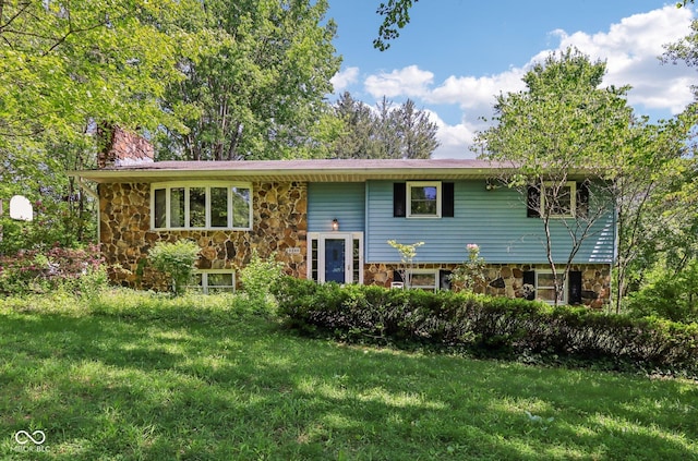 9240 E Woodview Dr, Bloomington, IN 47401 - raised ranch with stone siding, a chimney, and a front yard
