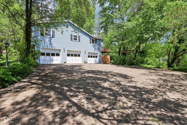 9240 E Woodview Dr, Bloomington, IN 47401 - view of property exterior featuring driveway and an attached garage