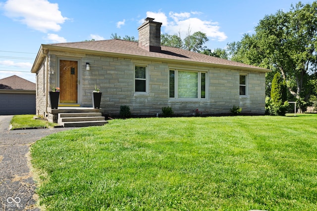 909 E Markwood Ave, Indianapolis, IN 46227 - back of property with stone siding, a chimney, a yard, and roof with shingles