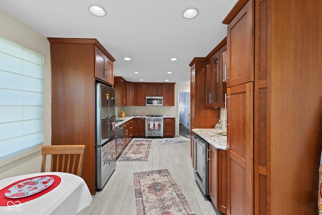 909 E Markwood Ave, Indianapolis, IN 46227 - kitchen featuring stainless steel appliances, wine cooler, recessed lighting, light wood-style flooring, and light stone counters